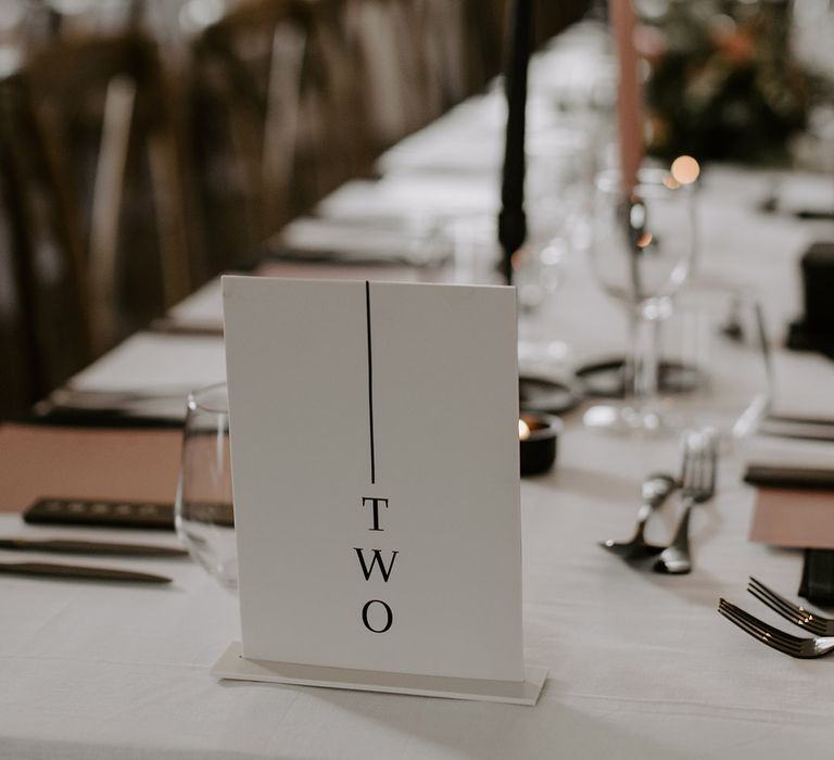 Black and white wedding table number sign with think black line in minimalist styling for the chic wedding 