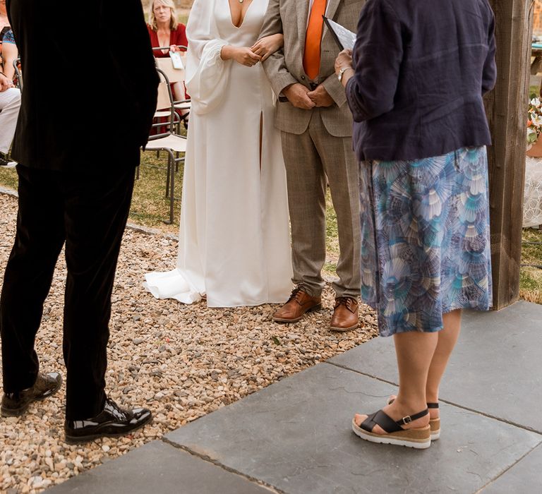 Father of the bride in beige wedding suit with orange tie for the retro 70s inspired wedding day at Hope Farm wedding venue in Dorset 