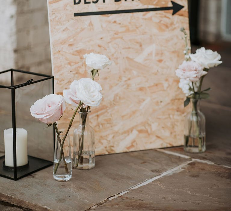 Wooden best day ever wedding sign with pink and white flowers in glass vases 