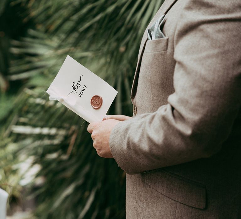 The groom reads personalised wedding vows from booklet 