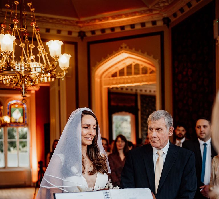 Bride wearing a wedding veil passed down from her grandmother with trim detail at mansion wedding 