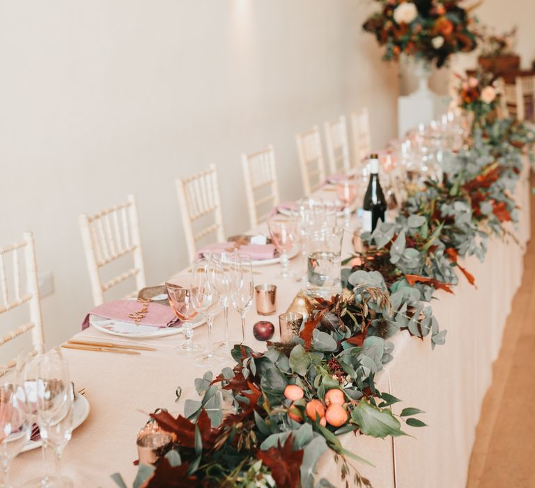 Millbridge Court top table wedding flowers with foliage and apples 