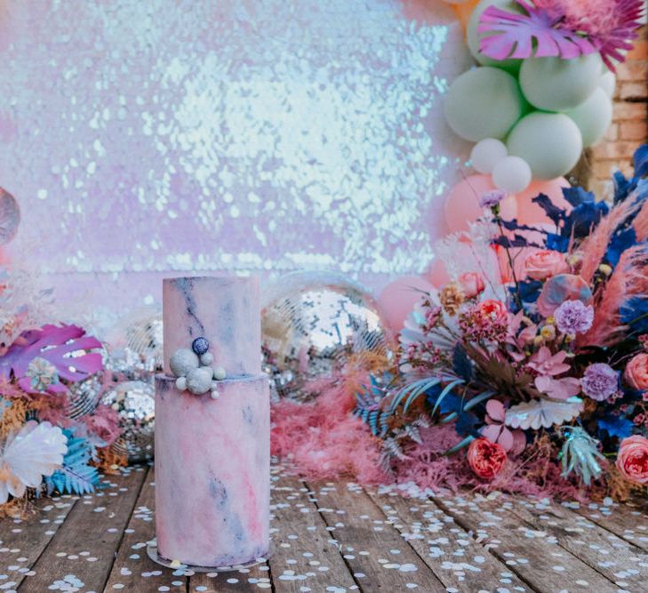 Pastel marble effect wedding cake with sequin backdrop 