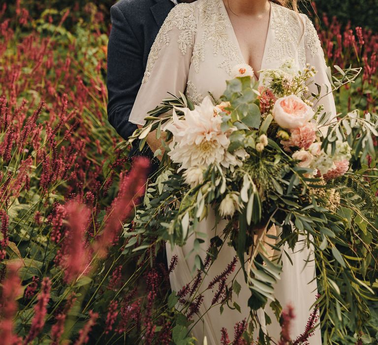 Groom kissing his bride in the gardens at CS Lewis House in Oxford 