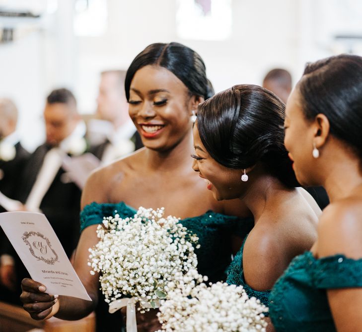 Bridesmaids in green dresses holding gypsophila bouquets 