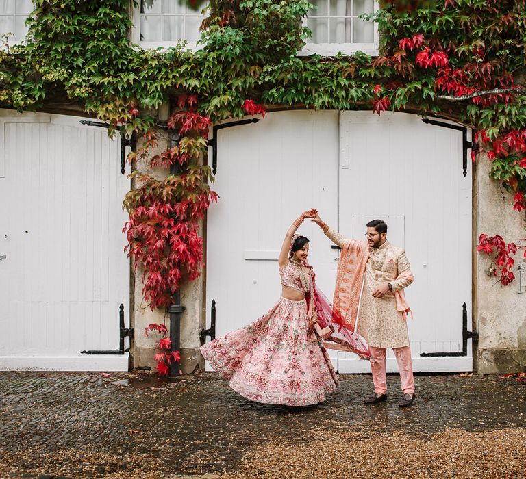 Indian bride and groom twirling at Northbrook Park wedding venue 