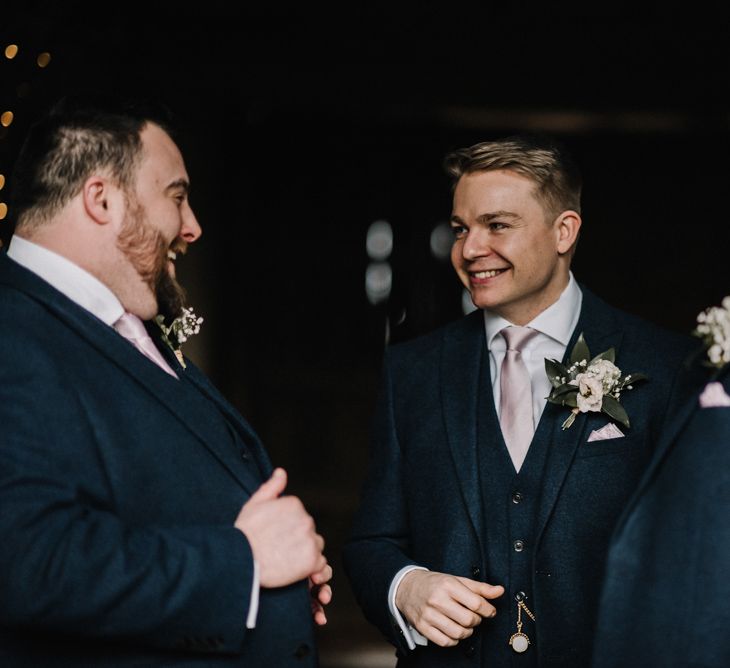 Groomsmen at stone barn wedding in spring