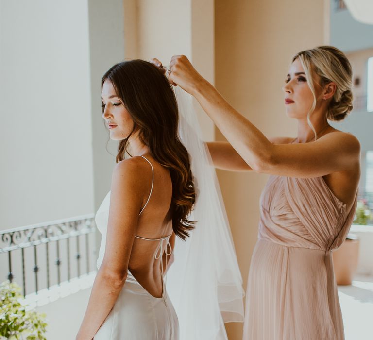 Bridesmaid fitting bride's veil for Cabo wedding