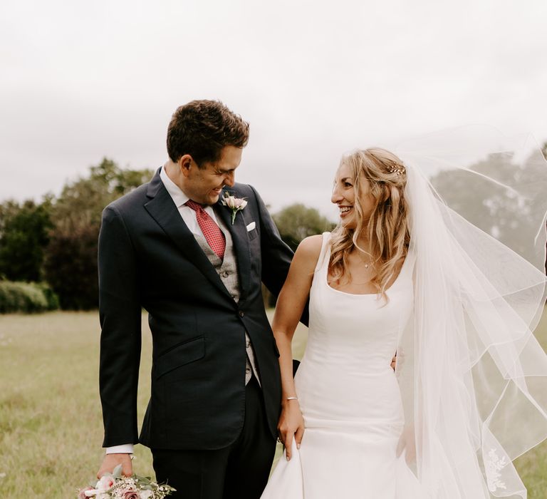 Bride and groom portrait in a field 