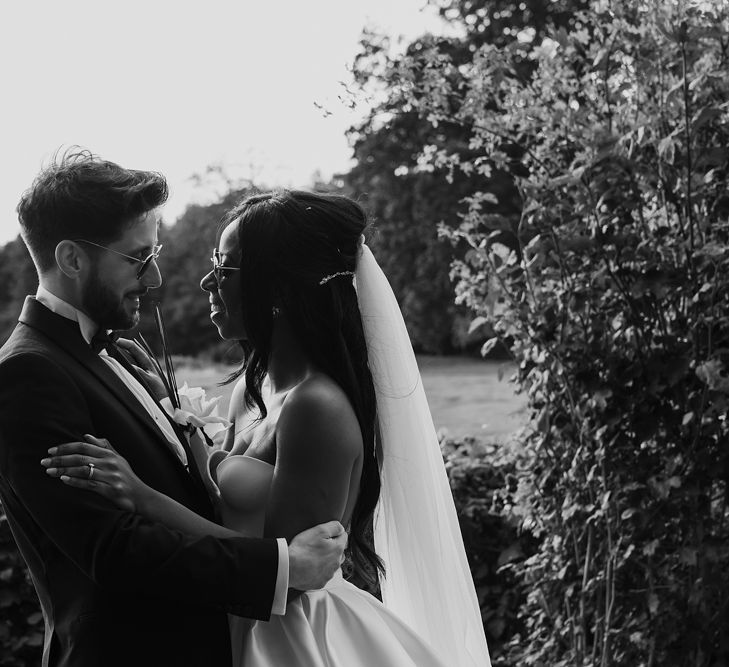 Black and white couples portrait of the bride and groom in their sunglasses 