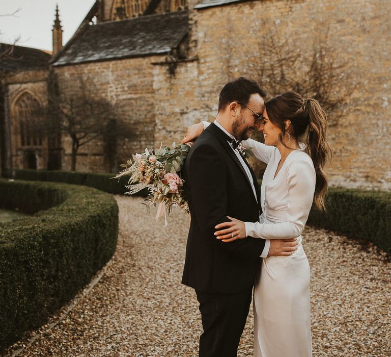 Bride & groom kiss on wedding day 