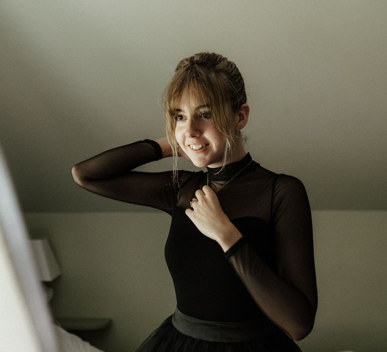 Bride wears long sleeved mesh black top 