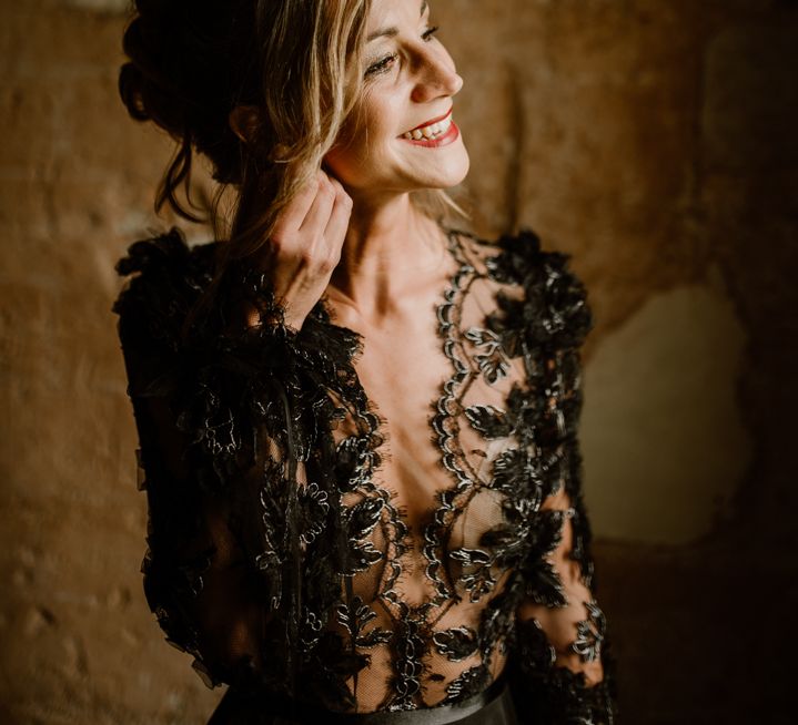 Bride in a black lace wedding dress with plunging neckline 