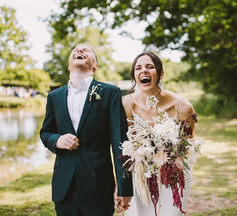 Bride & groom walk together on the day of their wedding