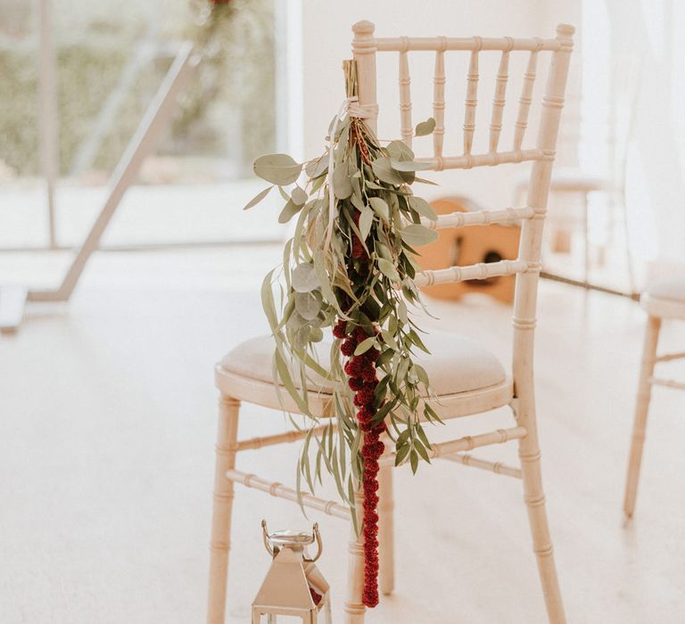 Eucalyptus and red flower chair back decor 