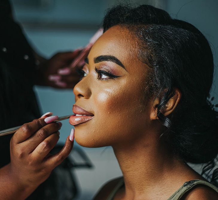 Black bride wedding makeup with winged eyeliner and shimmering eye shadow