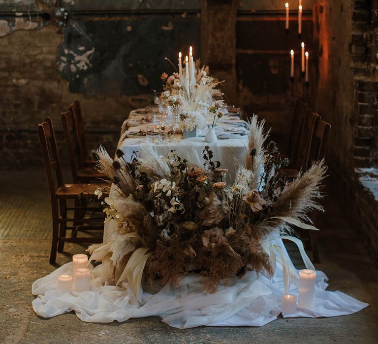 Intimate wedding reception table at The Asylum wedding venue with dried flower arrangements and candles 