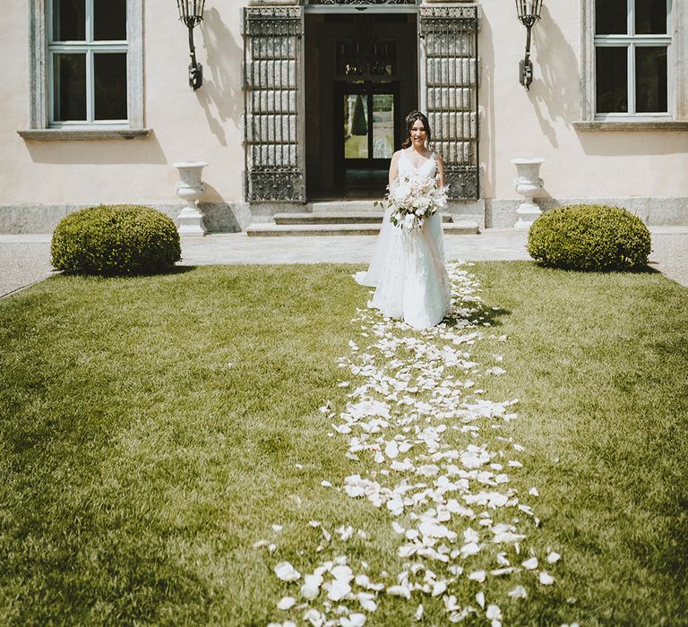 Bride walks down a petal walkway at the Villa Balbiano 