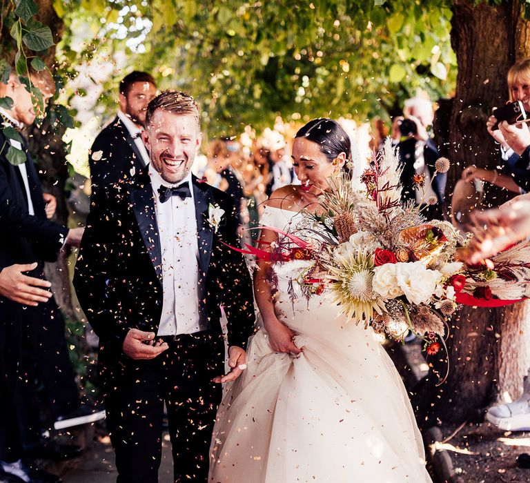 Bride and groom confetti exit