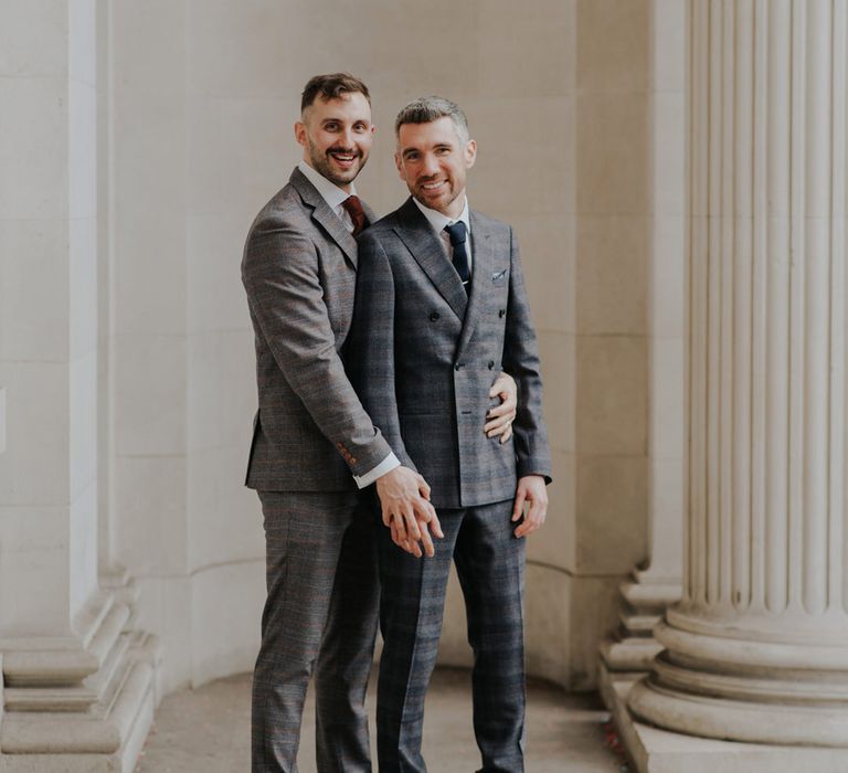 Two groomsmen in complementing grey check suits at Old Marylebone Town Hall wedding 