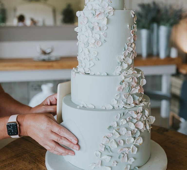 Four tier pastel blue iced wedding cake with decor for summer wedding at Primrose Hill Farm