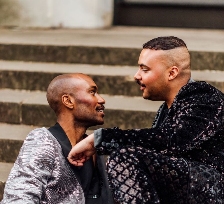 Intimate groom and groom portrait in a silver blazer and black mens sequin suit 