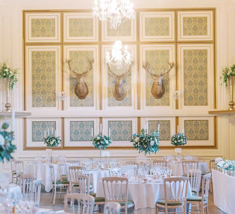 wedding reception at Drumtochty Castle with white and green flowers and gold cutlery 