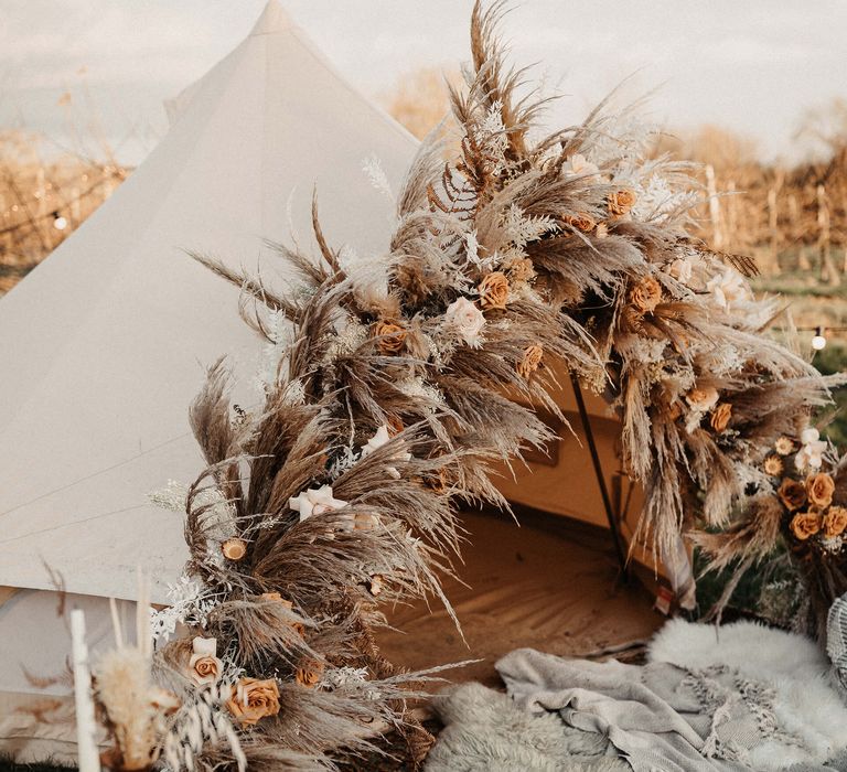 Bell tent with papas grass and dried wedding flowers decorating the entrance 