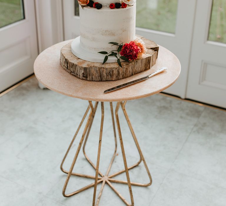 White naked cake complete with bright floral decor