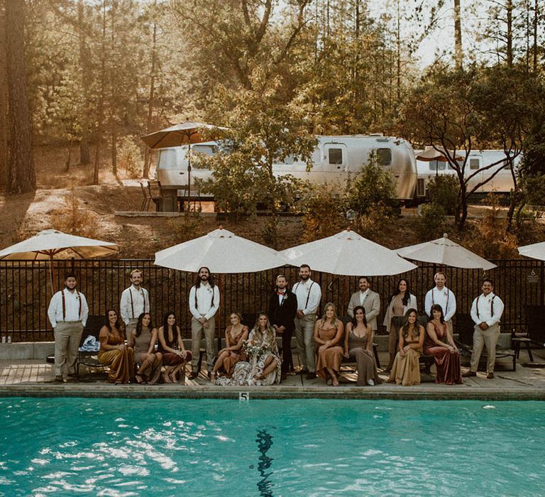 Wedding guests gather around poolside 