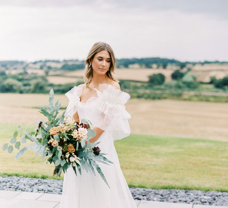 Bride in Halfpenny London wedding dress with ruffle sleeves