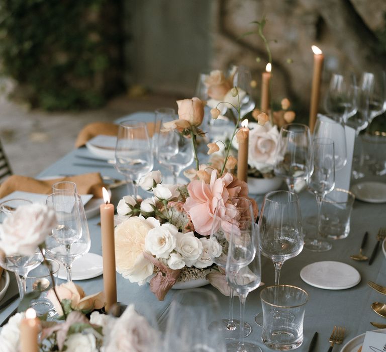 Small assortment of pink, white, toffee coloured flowers for wedding reception table settings