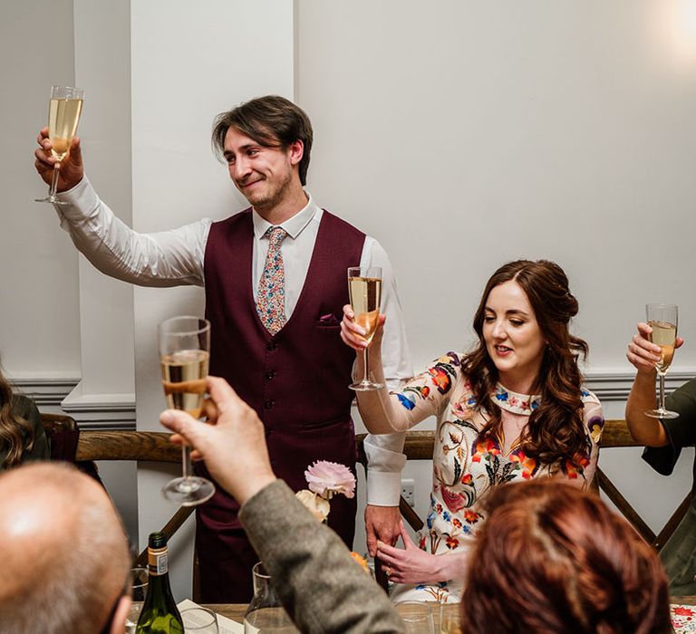 Everyone raises a toast while the groom gives his speech 