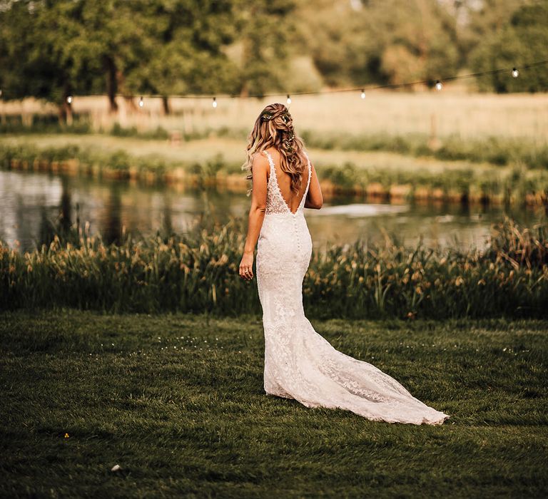 Bride in lace wedding dress with button detail