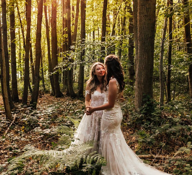 Woodland wedding with brides gazing lovingly at each other 