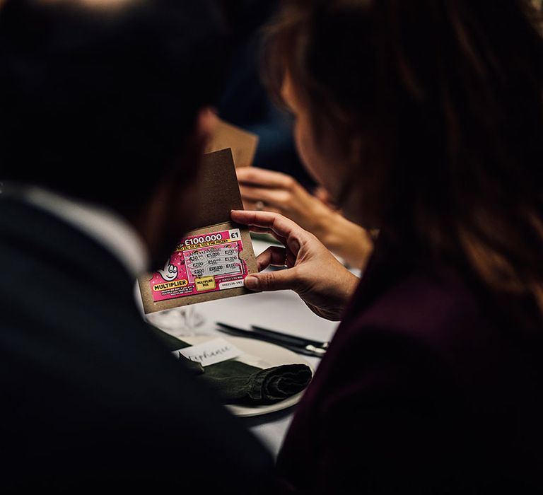 Guests open their lottery ticket wedding favours 