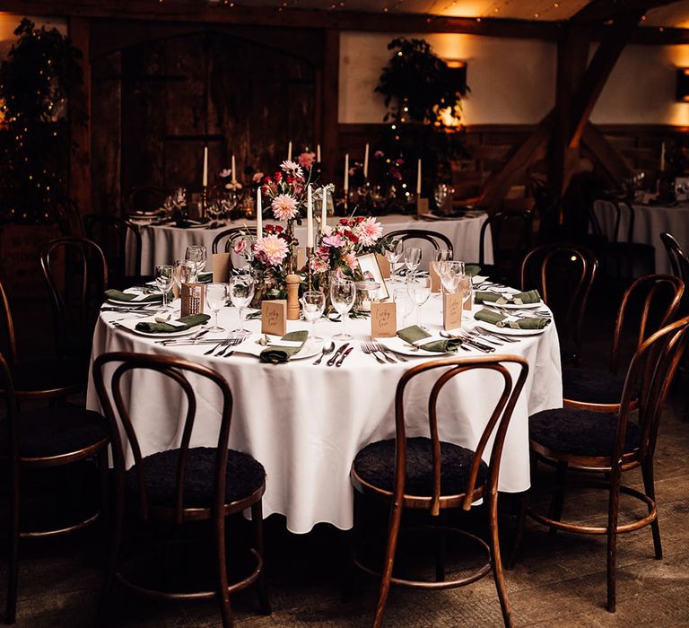 Wedding tablescape at Cripps Barn with pink and purple wedding flowers and green napkins 