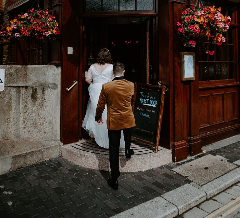 Bride and Groom enter wedding reception at pub venue