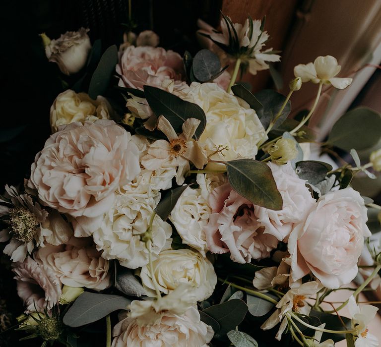 Bridal bouquet with white rose, eucalyptus, peonies and foliage 