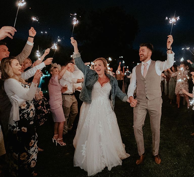 Bride & groom walk through sparkler exit on their wedding day 