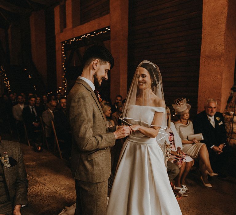 The groom places the wedding ring on the bride's finger as part of the civil wedding ceremony