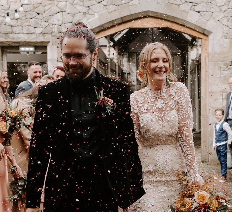 Fun colourful confetti moment for the newlyweds as they exit from the ceremony 