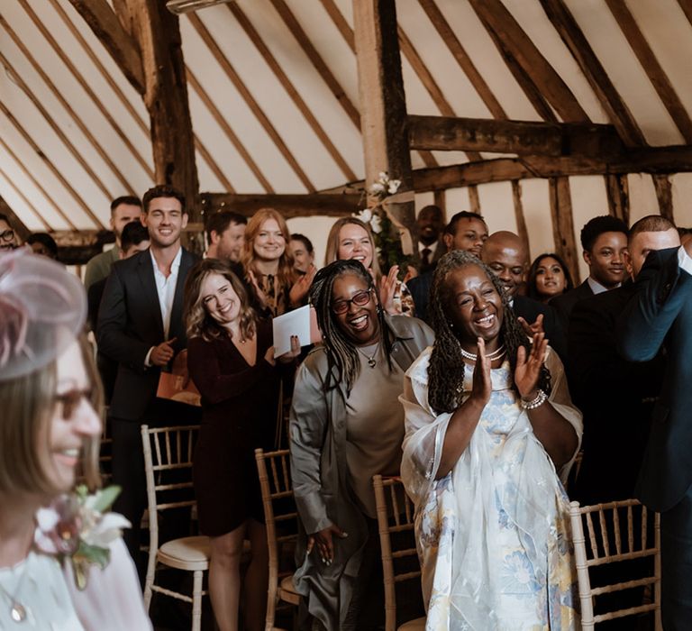 Wedding guests celebrate and laugh at the non-denominational wedding ceremony 