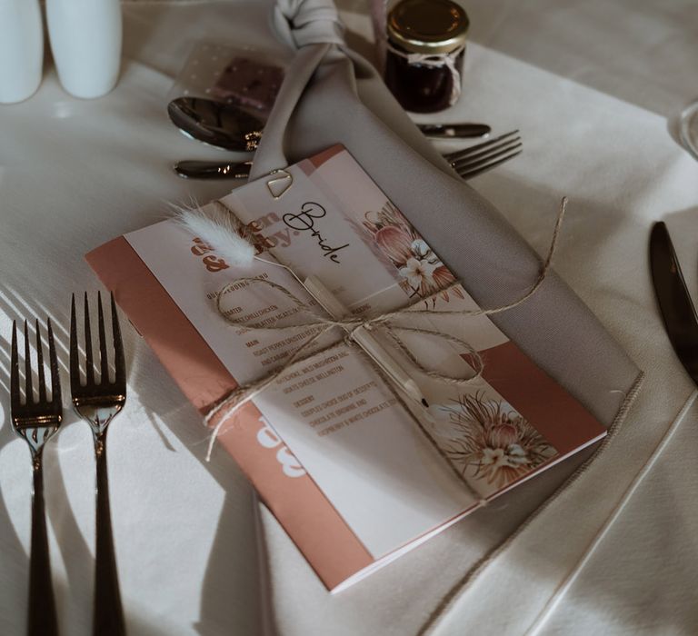 Delicate on the day wedding stationery with the wedding menu and booklet for guests to use 