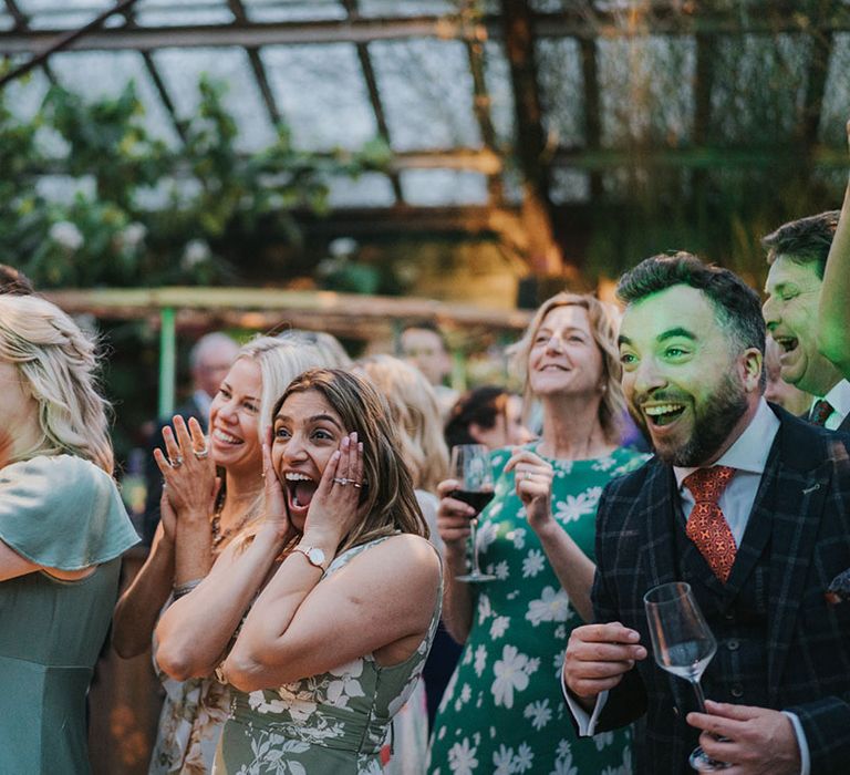 The wedding guests react to watching the bride give a surprise saxophone performance 