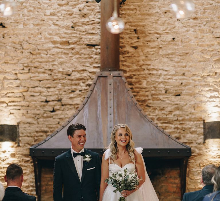 The bride and groom at their Stone Barn wedding venue in the Cotswolds 