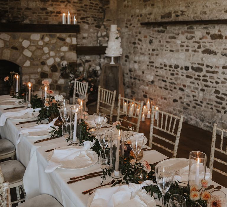 Rustic wedding tablescape with white wedding flowers and candles 