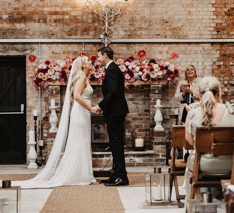 Bride and groom at wedding ceremony at The Barn at Botley Hill Barn 