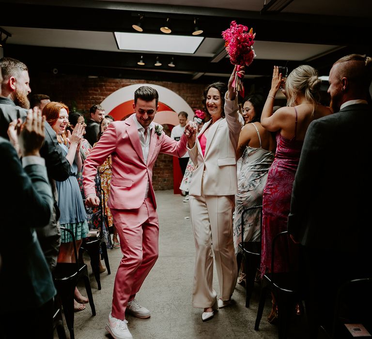 The bride and groom walk back down the aisle at The Shack Revolution together as a married couple 