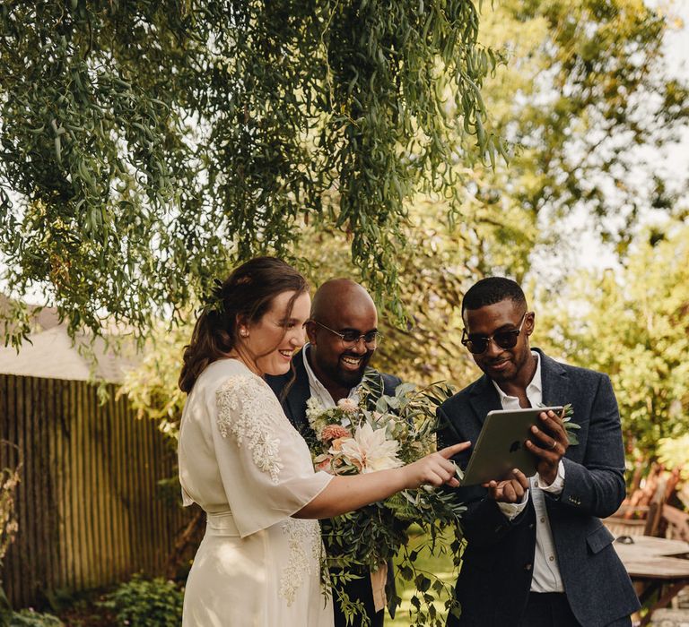 Bride and groom talking to virtual wedding guests